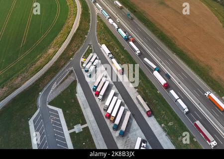 Vue aérienne du trafic logistique et des parkings pleins de camions sur l'autoroute en Pologne. Vue de drone. Banque D'Images