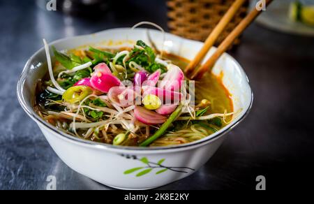 Bol blanc de pain Cha vietnamien avec légumes sur le dessus et baguettes sur le côté. Banque D'Images