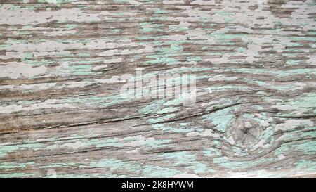 Fond en bois texturé avec vieille peinture rose craquelée et turquoise. Vue de dessus Banque D'Images