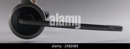 Casque avec microphone flottant dans l'air sur fond gris Banque D'Images