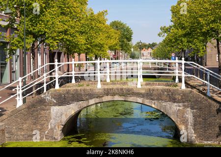 Pont en pierre sur le canal dans le centre de la ville historique hollandaise de Delft. Banque D'Images