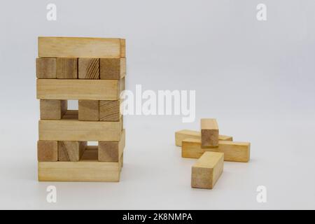 Tour en bois, construit tour à partir de blocs de bois sur fond blanc. Les briques de bois qui traînent au hasard Banque D'Images