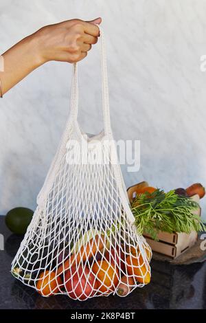 Femme tient un sac réutilisable éco shopping rempli de légumes frais - tomates, pommes de terre pourpres, aubergines, carottes, poivron. Problème écologique, éco Banque D'Images