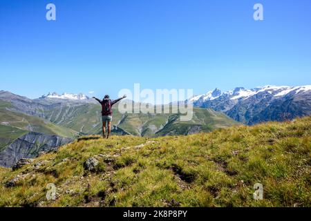 Bonne femme de trekker regardant les crêtes d'Aiguilles d'Arves et le célèbre glacier la Meijé en été, Alpes, France, Europe Banque D'Images