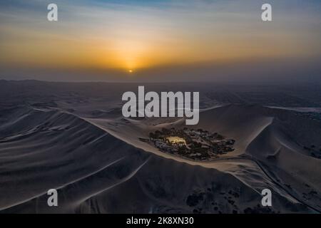 Vue aérienne de l'oasis du désert de Huacachina au Pérou au coucher du soleil. Banque D'Images