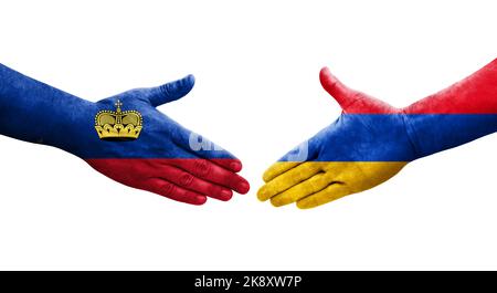 Poignée de main entre l'Arménie et le Liechtenstein drapeaux peints sur les mains, image transparente isolée. Banque D'Images