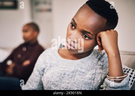 Peut-être que cette relation n'était pas censée être. Une jeune femme attrayante regardant bouleversé après avoir eu un argument avec son petit ami à la maison. Banque D'Images