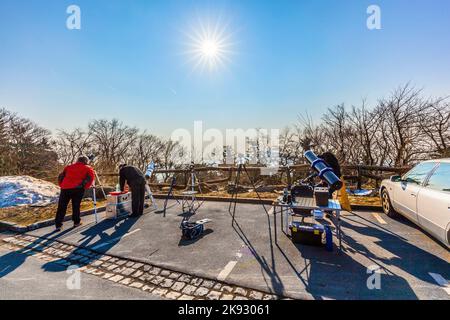 SCHMITTEN, ALLEMAGNE - 20 MARS 2014 : station de radio et de télévision au Mont Grosser Feldberg à Schmitten, Allemagne. Les gens regardent l'éclipse partielle. Banque D'Images