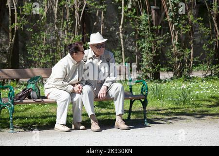 SALZBOURG, AUTRICHE - 21 avril 2015 : les personnes se détendent sur un banc dans le jardin Mirabell de Salzbourg, Autriche. Banque D'Images