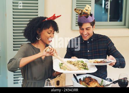 Ils nous ont tout servi dans une assiette. C'est un beau jeune couple qui nous a servi des repas ensemble lors d'une fête de Noël pour le déjeuner. Banque D'Images