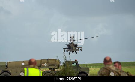 Gros plan de ZM707 hélicoptères d'attaque Boeing Apache de l'armée britannique (AH-64E ArmyAir606) qui décollent après avoir ravitaillé dans une voie de campagne Banque D'Images