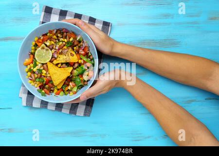 Caviar de cowboy biologique maison avec haricots de maïs, tomates, poivrons, lime, avocat, Fond en bois d'oignon Banque D'Images