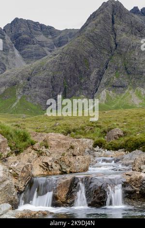 Longue ligne de chutes d'eau et de piscines de montagne rocheuses au pied des montagnes Black Cuillin, site touristique populaire, spectaculaire paysage de Skye, un chemin escarpé Banque D'Images