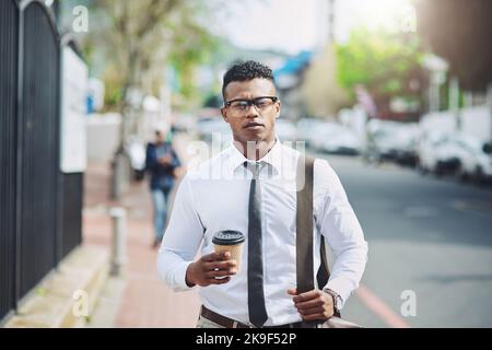 Marcher brusquement pour suivre le rythme des affaires. Un beau jeune homme d'affaires dans la ville. Banque D'Images