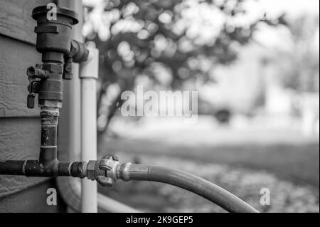 Hivernage d'un système d'irrigation résidentiel à l'aide d'un compresseur et d'air forcé pour souffler les conduites vides. Banque D'Images