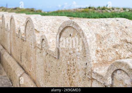 Une clôture en pierre calcaire ou une frontière décorée de petites et grandes arches en pierre autour de la chapelle Saint Dimitri dans le village rural de Gharb, Gozo, Malte Banque D'Images