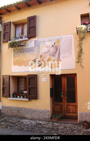 Dozza, Italie. Peintures murales sur la façade des bâtiments historiques. „Attraverso le Pareti Di B.“ par Aldo Galgano, 1983. Banque D'Images