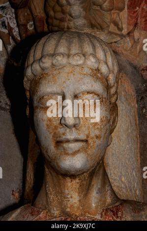 Le visage de Saint Stephen, le premier martyr chrétien, a lapidé à mort après avoir dénoncé ses juges. Détail tête et épaules de la statue de pilier romane de la fin du 12th siècle dans le portail nord de la Basilique Saint-Just, consacrée en l'an 1200 à Valcabrère en Occitanie, dans le sud-ouest de la France. Une capitale sculptée au-dessus de la tête de Stephen dépeint son martyre. Banque D'Images