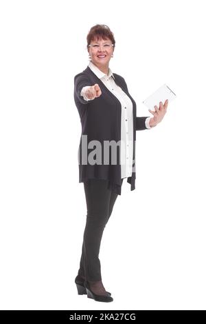 Bonne femme âgée debout, tenant une tablette informatique, regardant l'appareil photo. Banque D'Images