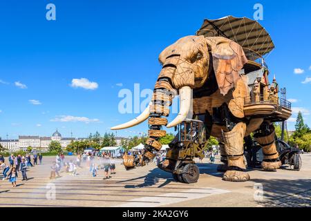 La marionnette géante du Grand Eléphant, qui fait partie des machines de l'attraction touristique de l'île de Nantes, pulvérise de l'eau avec son tronc sur les enfants excités. Banque D'Images