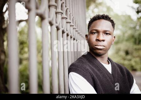 Jeune homme africain en plein air, confiant et sérieux étudiant portrait de rue, espace de copie. Automne ou printemps Banque D'Images