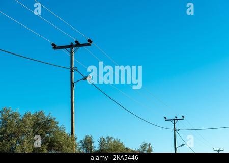 Câble d'électricité aérien sur des poteaux en bois apportant l'électricité aux zones rurales. Banque D'Images
