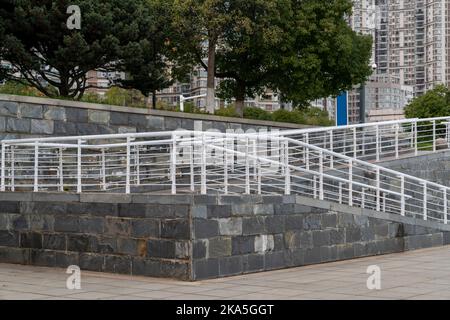 Une rampe pour fauteuil roulant, un avion incliné installé en plus ou à la place des escaliers, une passerelle pente pour personnes handicapées, personnes poussant des poussettes, des chariots Banque D'Images