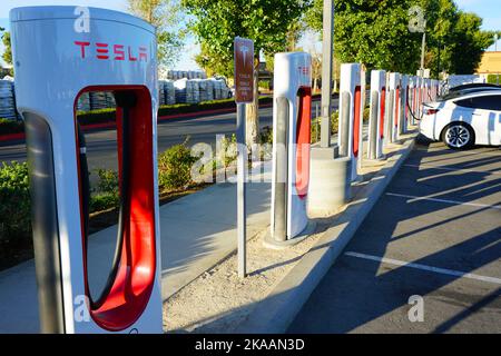 Menifee, CA, Etats-Unis - 31 octobre 2022: Une rangée de Tesla blanc charge aux stations de Supercharger Tesla. Banque D'Images