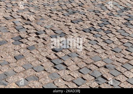 Vieux pavé de rue fait de blocs de pierre carrée, photo de fond Banque D'Images