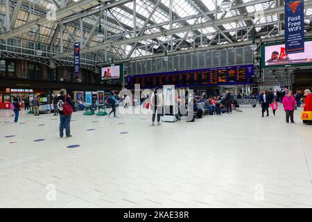 Foule de personnes attendant de monter à bord des trains dans la zone des départs de la gare centrale de Glasgow, Écosse, Royaume-Uni. Banque D'Images