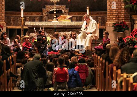 Le prêtre catholique dirige une messe spéciale de la veille de Noël pour enfants à l'église catholique Sainte-Claire d'Assise à Woodbridge, Ontario, Canada, on 24 décembre 2016. (Photo de Creative Touch Imaging Ltd./NurPhoto) *** Veuillez utiliser le crédit du champ de crédit *** Banque D'Images