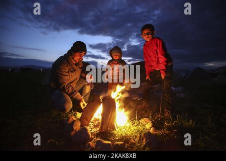 Les réfugiés et les migrants tentent de se réchauffer par des incendies dans le camp de fortune d'Idomeni, Grèce, février 2016. Ils utilisent tout pour soutenir le feu, même les plastiques, créant une atmosphère terrible et toxique. Les réfugiés sont bloqués à la frontière, car le passage de chemin de fer illégal est fermé. Depuis 2014, les réfugiés de Syrie, d'Irak, mais aussi d'Afghanistan, du Pakistan et d'autres pays du Moyen-Orient, ont commencé à affluer vers Idomeni afin de traverser les frontières grecques et d'entrer dans l'ARYM / République de Macédoine. Cette dernière et la Serbie au nord sont toutes deux en dehors de l'espace Schengen, c'est pourquoi le refus Banque D'Images