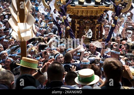 Les habitants d'Asakusa s'unissent pour porter un 'Mikoshi' (sanctuaires portables) pendant qu'ils chantent ensemble pendant le festival de Sanja devant le temple Senso-ji à Asakusa, Tokyo sur 20 mai 2017. Ces mikoshi sont transportés dans les rues d'Asakusa pour apporter chance, bénédictions et prospérité à la région et à ses habitants. (Photo de Richard Atrero de Guzman/NurPhoto) *** Veuillez utiliser le crédit du champ de crédit *** Banque D'Images