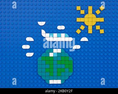 Tambov, Fédération de Russie - 14 juin 2022 Un avion qui vole autour du monde à travers les nuages. La scène est composée de points Lego. Banque D'Images