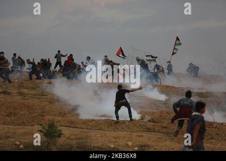 Les manifestants palestiniens portent des drapeaux nationaux lorsqu'ils se rassemblent lors d'une manifestation, à l'est de la ville de Gaza, près de la frontière israélienne sur 16 novembre 2018. - Le cessez-le-feu de Gaza, qui a mis fin à la pire flambée entre Israël et les dirigeants islamistes du territoire, le Hamas, depuis la guerre de 2014, est confronté à son premier test majeur sur l'16 novembre alors que les manifestants palestiniens devraient se rassembler le long de la frontière pour des manifestations de masse qui ont déclenché des violences mortelles les semaines précédentes. (Photo de Majdi Fathi/NurPhoto) Banque D'Images