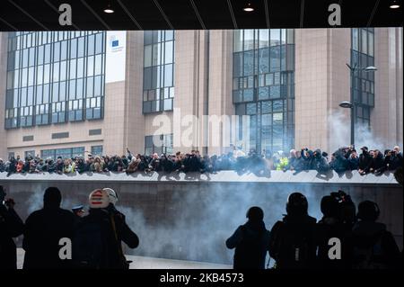 16 décembre 2018, à Bruxelles, Belgique. Un certain nombre d'associations belges de droite ont participé à la rencontre "la révolte contre Marrakech" à Bruxelles pour protester contre un pacte de l'ONU sur les migrations, qui a été adopté lors d'une conférence internationale à Marrakech. Selon la police, environ 5 500 personnes se sont rassemblées dimanche à Bruxelles pour protester contre le pacte de l'ONU sur les migrations. La police a déployé des gaz à effet de téargas et des canons à eau après que des éraflures ont éclaté. Des partisans d'extrême droite lancent des barricades et détruisent plusieurs propierties autour du bâtiment européen de l'Union à Schuman. La police est intervenue pour disperser la foule après des projectiles Banque D'Images