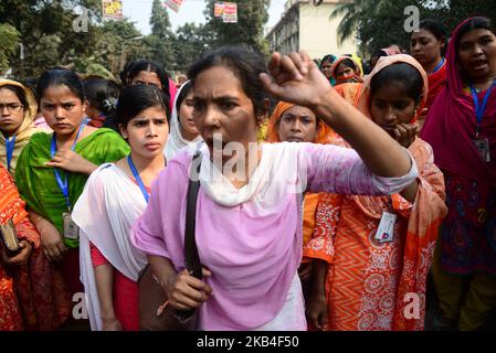 Les ouvriers bangladais du vêtement crient des slogans alors qu'ils bloquent une route lors d'une manifestation pour exiger des salaires plus élevés, à Dhaka, au Bangladesh, sur 12 janvier 2019 (photo de Mamunur Rashid/NurPhoto) Banque D'Images