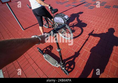 Un homme tenant un kick scooter et une femme avec un VTT attendant le train sur un arrêt de train de banlieue sont vus à Gdansk, en Pologne, le 22 septembre 2019 pendant le jour sans voiture chaque personne avec un document d'enregistrement valide de la voiture pourrait monter dans un transport en commun (bus, tram ou train) sans billet, totalement gratuit. Pendant la semaine de 22 septembre, la marche, le vélo, les transports en commun et le covoiturage sont les moyens de promouvoir les transports en commun. Les transports publics contribuent à économiser l'énergie et à réduire les émissions, car le nombre de véhicules a été réduit. (Photo de Michal Fludra/ Banque D'Images