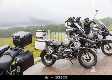 Motocyclistes en Écosse lors d'une excursion en moto, en compagnie de selfie de groupe et en train de monter à bord des motos BMW R1250 GS, Highlands écossais, Royaume-Uni, 2022 Banque D'Images