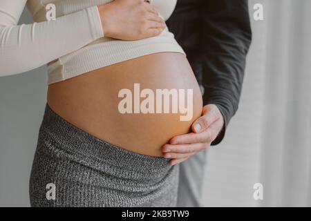 Couple s'attendant enfant bébé bosse homme caressant femme enceinte estomac pendant la grossesse. Séance de maternité Banque D'Images