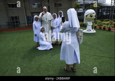 Une religieuse catholique thaïlandaise prendre une photo près de la statue du Pape François est exposé à l'hôpital Saint Louis à Bangkok, Thaïlande, 17 novembre 2019. (Photo par Anusak Laowilas/NurPhoto) Banque D'Images