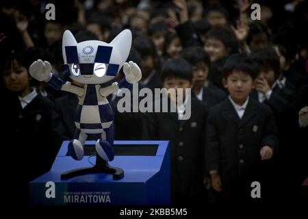 Les écoliers posent pour une photo avec la mascotte de type robot Miraitowa des Jeux Olympiques de Tokyo en 2020 lors d'une cérémonie à l'école élémentaire Hoyonomori à Tokyo sur 18 novembre 2019. (Photo par Alessandro Di Ciommo/NurPhoto) Banque D'Images