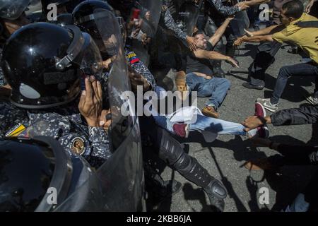 Les partisans du chef de l'opposition vénézuélienne et du président par intérim auto-proclamé Juan Guaido, ont fait des bagarre avec des membres de la police nationale bolivarienne alors qu'ils tentaient de bloquer une avenue principale lors d'une protestation contre le gouvernement du président Nicolas Maduro à Caracas, au Venezuela, sur 18 novembre 2019. (Photo de Rafael Briceno Sierralta/NurPhoto) Banque D'Images