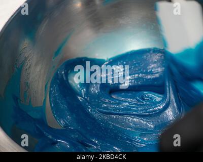 chef pâtissier concepteur de gâteaux préparant un cheesecake blanc bleu dans un laboratoire de cuisine Banque D'Images
