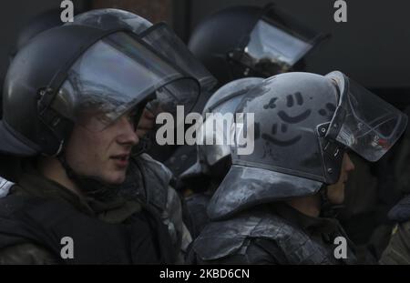 Un soldat de la garde nationale est vu couvert de poudre d'extincteur après le clash avec les militants des mouvements ukrainiens d'extrême droite lors d'une protestation des ouvriers agricoles contre la réforme agraire à Kiev, Ukraine, 17 décembre, 2019.des dizaines d'activistes d'extrême-droite se sont affrontés avec la police devant le Parlement ukrainien alors que des personnes ont protesté pacifiquement contre une éventuelle loi sur le marché foncier qui a été adoptée par les législateurs de la Verkhovna Rada. En novembre 2019, le Parlement a adopté la première lecture d'un projet de loi du gouvernement sur la modification de certains actes législatifs de l'Ukraine concernant le chiffre d'affaires du réseau local agricole Banque D'Images