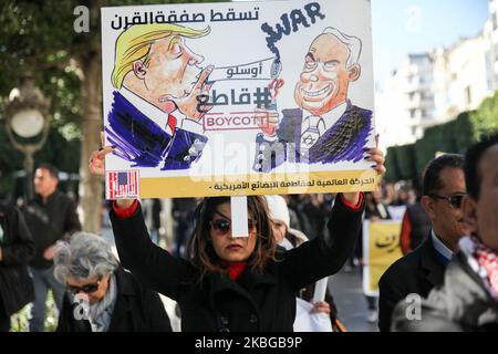 Une protestante tunisienne élève une écriteau avec des caricatures du président américain Donald Trump et du premier ministre israélien Benyamin Netanyahou, qui lit en arabe, « duwn with the Deal of the Century » lors d'une marche nationale qui s'est tenue sur la principale avenue Habib Bourguiba pour protester contre le « plan de paix » pour le Moyen-Orient appelé « plan du siècle » dévoilé par le président américain Donald Trump, à Tunis, en Tunisie, sur 05 février, 2020. (Photo de Chedly Ben Ibrahim/NurPhoto) Banque D'Images