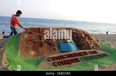 Une sculpture de sable est vue à la plage de la côte est de la baie de la mer du Bengale alors qu'elle est créée par l'artiste indien de sable Manas Sahoo pour les visiteurs de sensibilisation sur le coronavirus chinois à Puri, à 65 km de l'est de l'état indien Odisha capitale de Bhubaneswar. (Photo par STR/NurPhoto) Banque D'Images