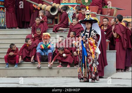 De jeunes moines tibétains s'assoient autour d'un moine portant un masque d'achara (joker) lors de la représentation spirituelle de la danse cham au monastère de Shechen à Boudhanath dans le cadre des célébrations du nouvel an tibétain de Losar, le 22 février 2020 à Katmandou, Népal. La danse rituelle cham exécutée avant le nouvel an symbolise l'élimination des obstacles et l'énergie négative. (Photo de Wiktor Szymanowicz/NurPhoto) Banque D'Images