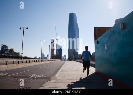 La tour One Blackfriars surplombe un pont déserté Blackfriars, vide en plus d'un homme de jogging, à Londres, en Angleterre, sur 25 mars 2020. Autour d'un pays en grande partie fermé, le coronavirus Covid-19 continue de répandre l'anxiété et les perturbations, avec des conditions de verrouillage imposées lundi soir par le Premier ministre britannique Boris Johnson dès aujourd'hui dans leur deuxième jour. Il a été annoncé aujourd'hui que le prince Charles, héritier du trône britannique âgé de 71 ans, s'est révélé positif pour le coronavirus et a des « symptômes légers ». Au total, 468 personnes sont mortes après avoir été infectées par le coronavirus au Royaume-Uni. (PH Banque D'Images