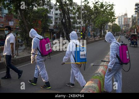 Les volontaires vaporisent du désinfectant dans des rues presque vides, tandis que le confinement imposé par le gouvernement comme mesure préventive contre la coronavirus (COVID-19) à Narayanganj, au Bangladesh, sur 29 mars 2020. (Photo par Ziaul Haque/NurPhoto) Banque D'Images